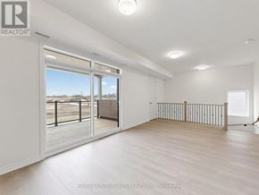 Clarington (Courtice) apartment for rent - A spacious room with a sliding glass door leading to a balcony.