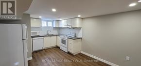 Hamilton (Inch Park) apartment for rent - A well-lit kitchen with white cabinets and a wooden floor.
