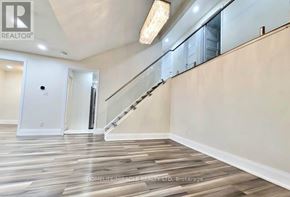 Kitchener apartment for rent - A spacious hallway with wooden flooring and a staircase.