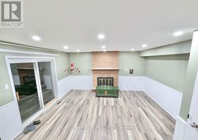 Kitchener apartment for rent - A room with a fireplace and wooden floors.