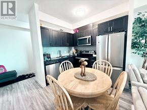 Waterloo condo for rent - A kitchen with a table and chairs in the foreground.