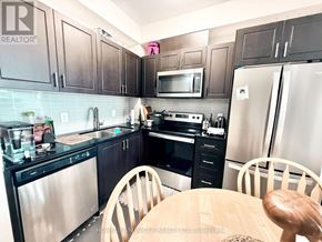 Waterloo condo for rent - A kitchen with black cabinets and stainless steel appliances.