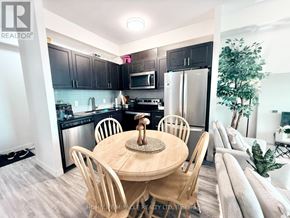 Waterloo condo for rent - A modern kitchen with a wooden table and chairs.