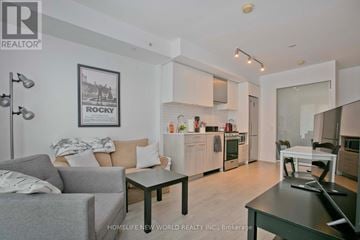 Toronto (Moss Park) condo for rent - A modern living room with a grey couch and a coffee table.