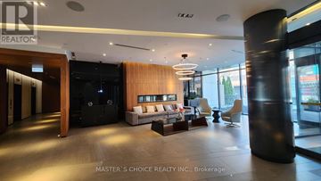Toronto (Kensington-Chinatown) townhouse for rent - A modern living room with a black sofa and a wooden coffee table.