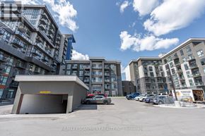 Hamilton (Waterdown) condo for rent - A parking lot with cars and a building in the background.