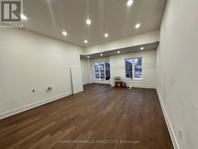 Whitby (Williamsburg) apartment for rent - A spacious room with wooden flooring and a large window.