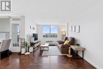 Toronto (Humber Summit) condo for rent - A living room with a brown couch and a coffee table.
