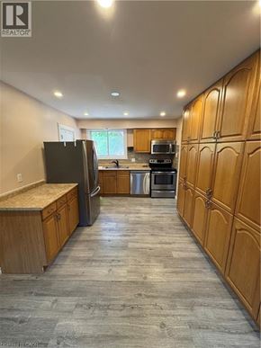 Kitchener apartment for rent - A living room with a grey couch and a television.