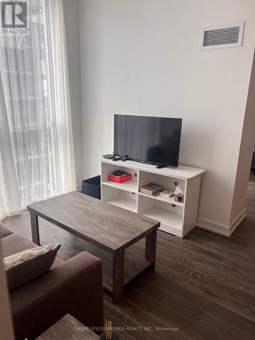 Toronto (Annex) condo for rent - A living room with a television and a coffee table.