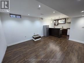 Milton (Sc Scott) apartment for rent - A well-lit room with wooden flooring and a kitchenette area.