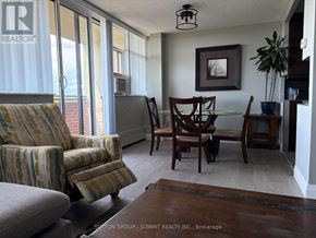 Mississauga (Meadowvale) condo for rent - A living room with a couch, chair, and dining table.