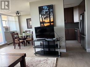Mississauga (Meadowvale) condo for rent - A living room with a flat screen TV and a dining table.
