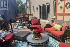 Burlington (Alton) apartment for rent - A patio with a table, chairs, and a vase of flowers.