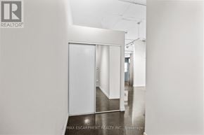Hamilton (Durand) condo for rent - A hallway with a white door and a white wall.