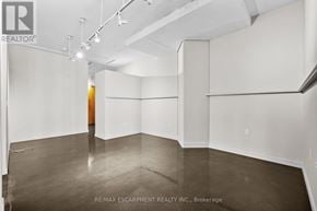 Hamilton (Durand) condo for rent - A large empty room with a door on the left side.