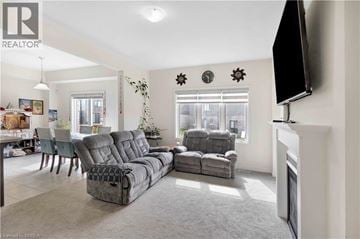 Paris apartment for rent - A living room with grey sofas and a television mounted on the wall.