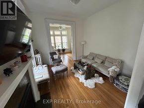 London East (East F) fourplex for rent - A living room with a couch, chair, and coffee table.