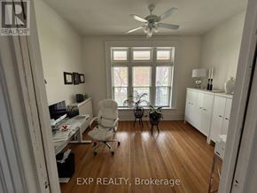 London East (East F) fourplex for rent - A room with a desk, chair, and a fan.