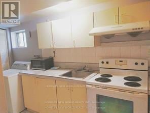 Toronto (Don Valley Village) apartment for rent - A kitchen with a white stove top oven and white cabinets.