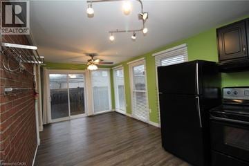 Hamilton apartment for rent - A kitchen with a black refrigerator and wooden floors.