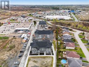 North Grenville multi-family for rent - A bird's eye view of a residential area with houses and a shopping center.