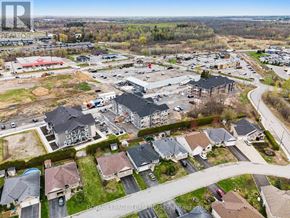 North Grenville multi-family for rent - A bird's eye view of a residential area with houses and a shopping center.