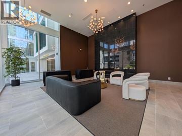 Burnaby apartment for rent - A modern living room with a black sofa and a glass wall.