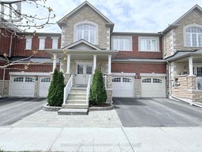Markham (Wismer) townhouse for rent - A large house with a front porch and a garage.
