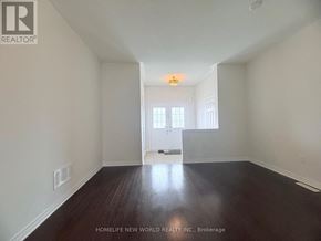 Markham (Wismer) townhouse for rent - A room with wooden floors and white walls.