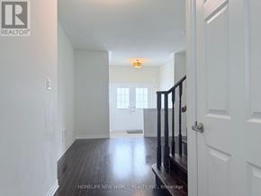 Markham (Wismer) townhouse for rent - A hallway with a wooden floor and white walls.