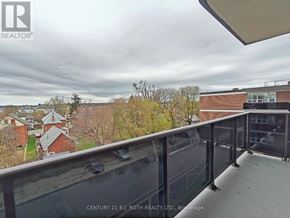 Barrie (Allandale) apartment for rent - A balcony with a glass railing overlooking a residential area.