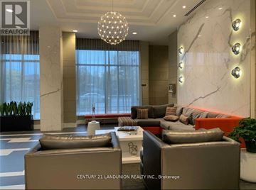 Toronto (Henry Farm) condo for rent - A modern living room with a large sofa and a chandelier.