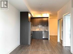 Toronto (Henry Farm) condo for rent - A kitchen with a refrigerator, cabinets, and a countertop is shown in a real estate listing.