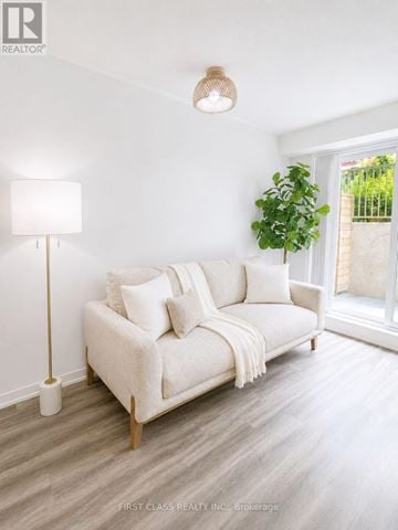 Toronto (New Toronto) townhouse for rent - A modern kitchen with a glass table and white chairs.