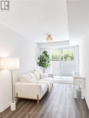 Toronto (New Toronto) townhouse for rent - A bedroom with a large bed and a window overlooking a fence.