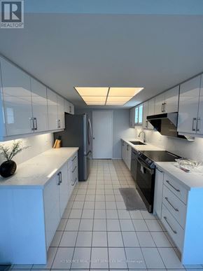 Toronto (Milliken) condo for rent - A living room with a sofa, chairs, and a dining table.