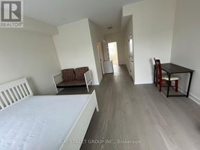 Toronto (Downsview-Roding-Cfb) townhouse for rent - A bedroom with a bed, chair, and dining table.