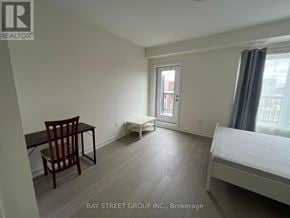 Toronto (Downsview-Roding-Cfb) townhouse for rent - A bedroom with a bed, chair, and desk.
