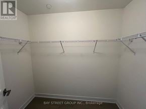 Toronto (Downsview-Roding-Cfb) townhouse for rent - A white closet with a metal rod for hanging clothes.