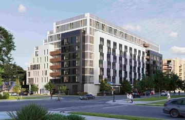 Toronto apartment for rent - A modern multi-story building with a mix of white and darker colored windows is depicted.