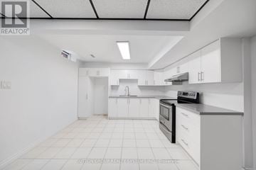 Newmarket (Armitage) apartment for rent - A white kitchen with a black stove top oven.