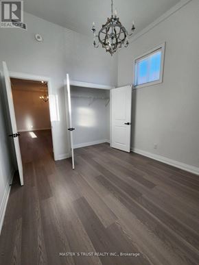 Uxbridge condo for rent - A room with a chandelier and a window.