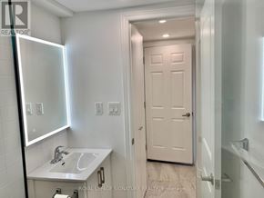 Toronto (Yorkdale-Glen Park) apartment for rent - A white bathroom with a sink, mirror, and toilet.