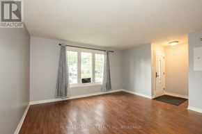 Welland (Lincoln/Crowland) apartment for rent - A room with wooden floors and a window with curtains.