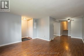 Welland (Lincoln/Crowland) apartment for rent - A room with wooden floors and white walls, with a door on the left and a staircase on the right.