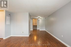 Welland (Lincoln/Crowland) apartment for rent - A long hallway with wood floors and white walls.
