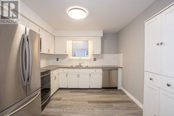 Welland (Lincoln/Crowland) apartment for rent - A kitchen with white cabinets and a stainless steel refrigerator.