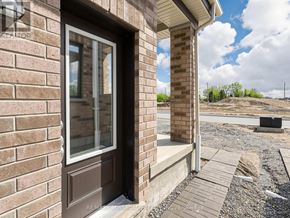 Clarington (Courtice) apartment for rent - A house under construction with a brown door and windows.