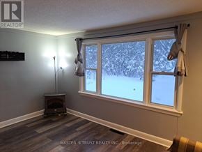 Orillia apartment for rent - A room with a window showing a snowy scene outside.